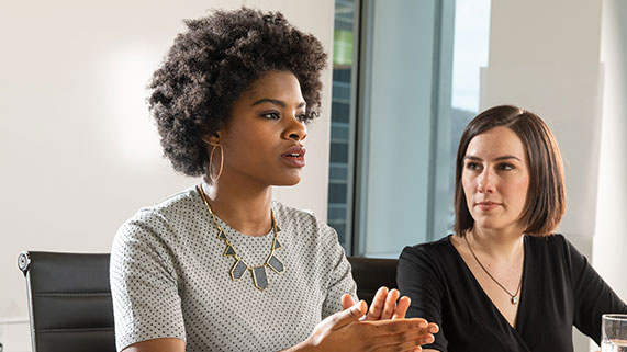woman speaking at table